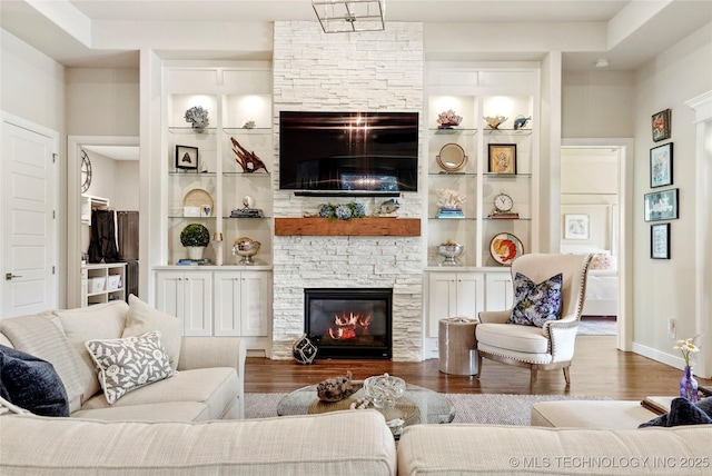 8701 E Hartford St, Broken Arrow, OK 74014 - living area featuring a fireplace, wood finished floors, and built in shelves