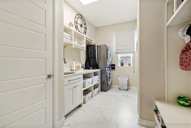 8701 E Hartford St, Broken Arrow, OK 74014 - laundry room featuring stacked washer / dryer and light marble finish floors