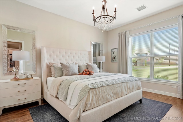 8701 E Hartford St, Broken Arrow, OK 74014 - bedroom featuring a chandelier and wood finished floors