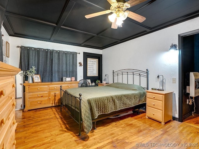 10696 N County Road 3410, Stratford, OK 74872 - bedroom with coffered ceiling, light wood-style floors, heating unit, and ceiling fan