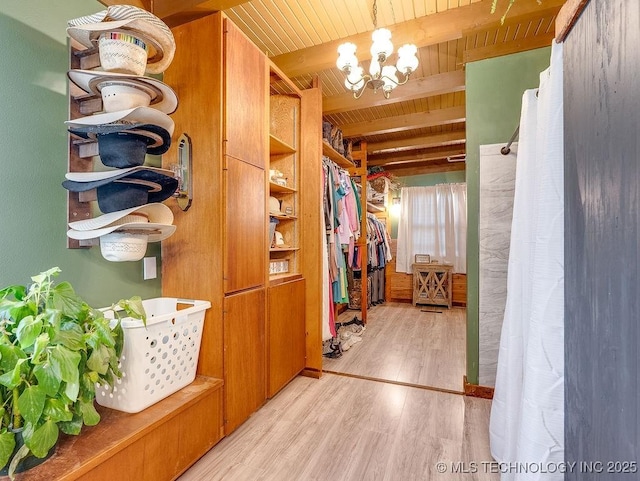 10696 N County Road 3410, Stratford, OK 74872 - spacious closet featuring wood finished floors, a chandelier, and beam ceiling