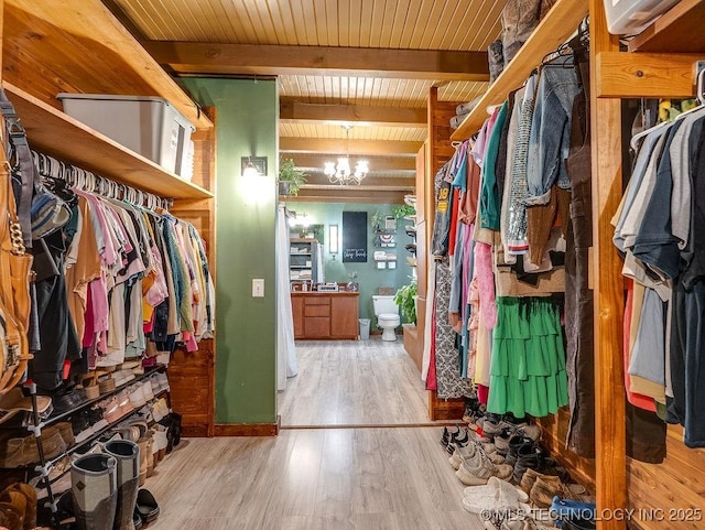 10696 N County Road 3410, Stratford, OK 74872 - spacious closet featuring wood finished floors, a chandelier, and beamed ceiling
