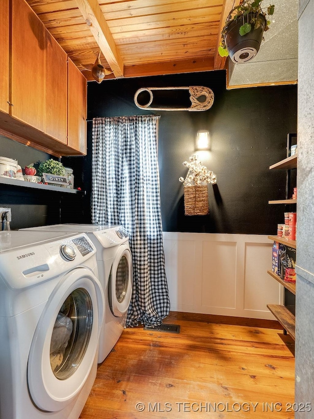 10696 N County Road 3410, Stratford, OK 74872 - laundry area with cabinet space, washing machine and dryer, light wood-style flooring, wood ceiling, and a wainscoted wall