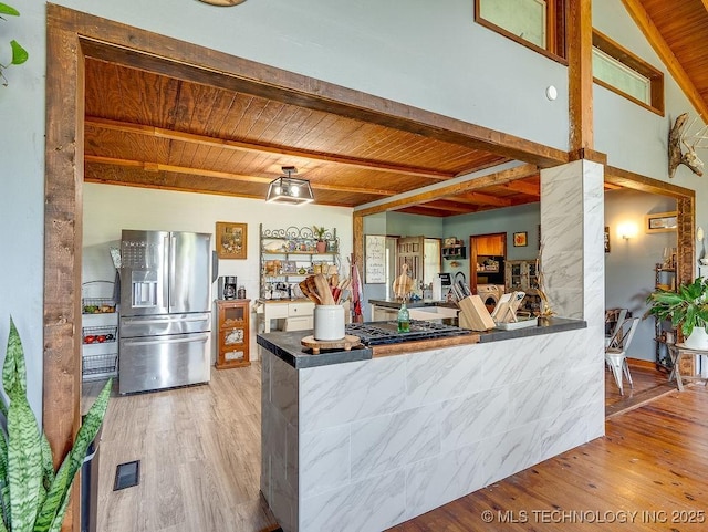 10696 N County Road 3410, Stratford, OK 74872 - kitchen featuring appliances with stainless steel finishes, a wood ceiling with exposed beams, and light wood-style floors