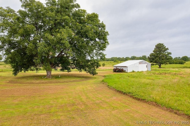 10696 N County Road 3410, Stratford, OK 74872 - view of yard featuring a pole building, an outdoor structure, and a view of rural / pastoral area