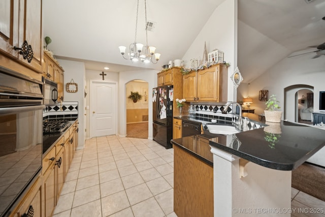 13605 E 90th Ct, Owasso, OK 74055 - kitchen featuring arched walkways, black appliances, lofted ceiling, backsplash, and dark countertops
