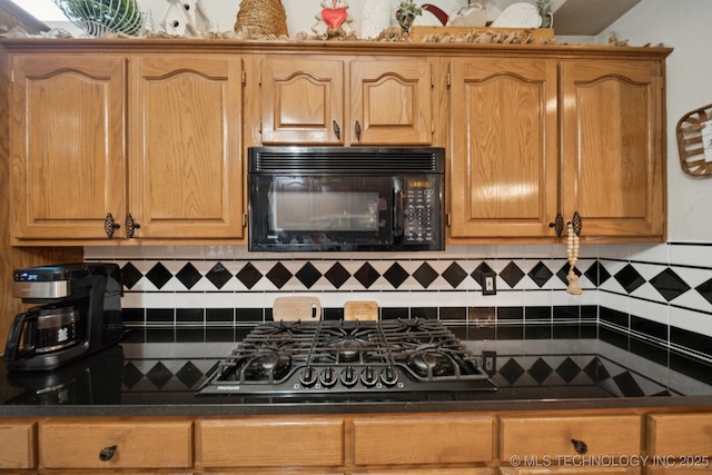 13605 E 90th Ct, Owasso, OK 74055 - kitchen featuring black microwave, stainless steel gas cooktop, decorative backsplash, and dark countertops