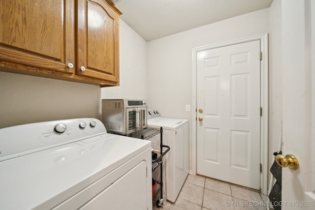 13605 E 90th Ct, Owasso, OK 74055 - laundry room with washing machine and dryer, cabinet space, and light tile patterned floors