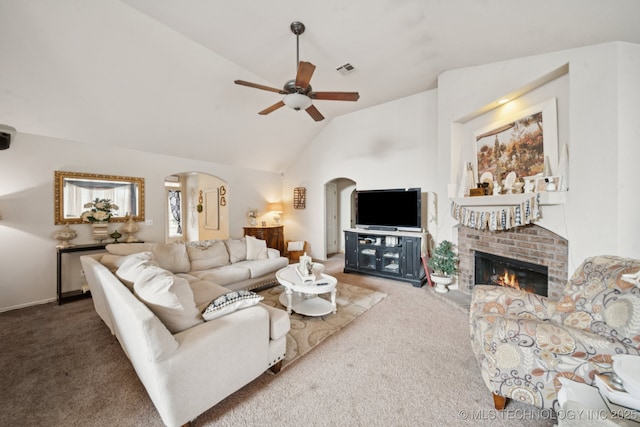 13605 E 90th Ct, Owasso, OK 74055 - carpeted living room with arched walkways, ceiling fan, a fireplace, and high vaulted ceiling