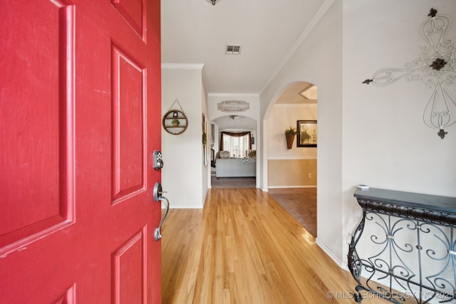 13605 E 90th Ct, Owasso, OK 74055 - entrance foyer with ornamental molding, arched walkways, and light wood-style floors