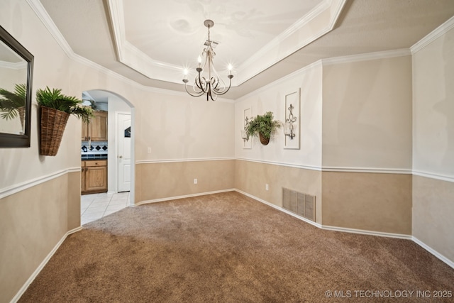 13605 E 90th Ct, Owasso, OK 74055 - unfurnished room with arched walkways, light carpet, ornamental molding, a chandelier, and a raised ceiling