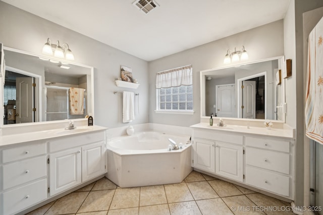 13605 E 90th Ct, Owasso, OK 74055 - full bath featuring two vanities, tile patterned flooring, a shower stall, and a bath