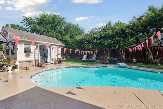 13605 E 90th Ct, Owasso, OK 74055 - view of swimming pool with an outdoor structure, a fenced backyard, a patio area, and an exterior structure