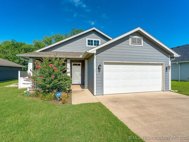 1125 Emily Ln, Ada, OK 74820 - view of front of home featuring an attached garage, a front yard, and driveway
