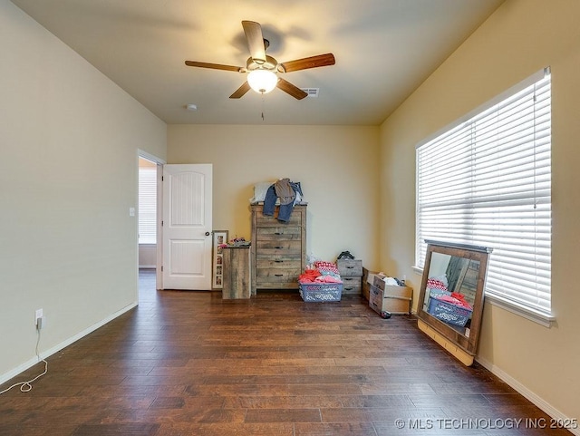 1125 Emily Ln, Ada, OK 74820 - unfurnished room featuring a ceiling fan, plenty of natural light, and dark wood-type flooring