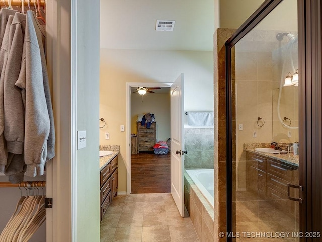 1125 Emily Ln, Ada, OK 74820 - full bathroom with vanity, a bath, tile patterned flooring, ceiling fan, and tiled shower