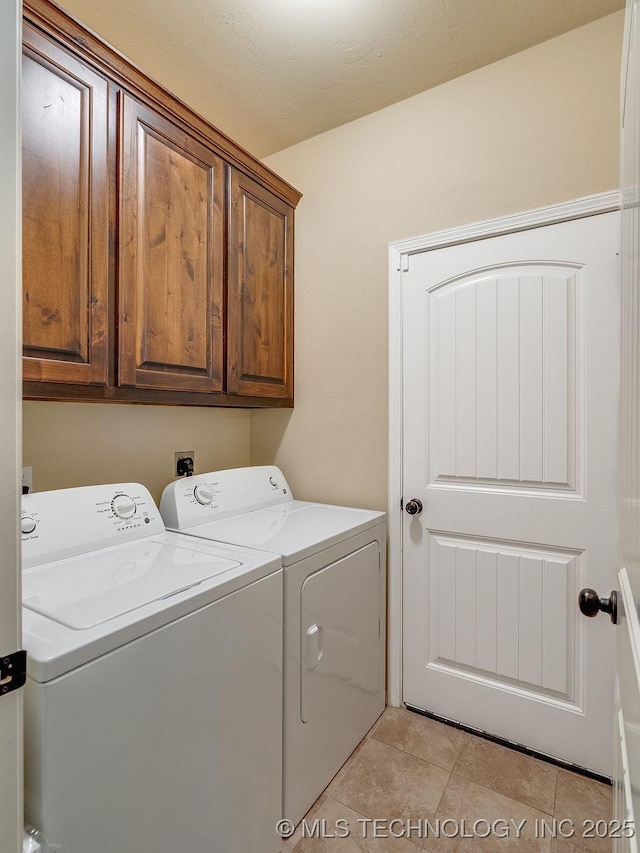 1125 Emily Ln, Ada, OK 74820 - laundry area with washer and dryer, cabinet space, and light tile patterned floors
