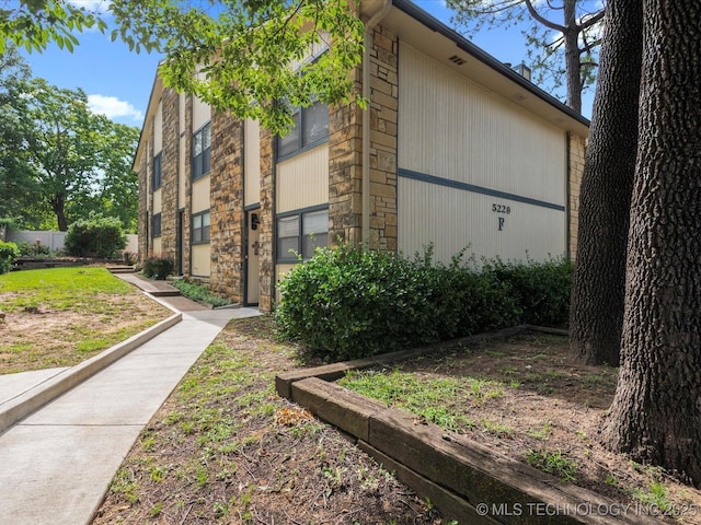 5229 Nowata Rd Unit F101, Bartlesville, OK 74006 - view of home's exterior featuring stone siding