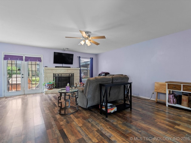 5229 Nowata Rd Unit F101, Bartlesville, OK 74006 - living area featuring healthy amount of natural light, wood finished floors, ceiling fan, and a stone fireplace