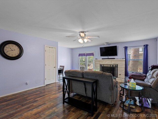 5229 Nowata Rd Unit F101, Bartlesville, OK 74006 - living room featuring a ceiling fan, a fireplace, and dark wood-type flooring