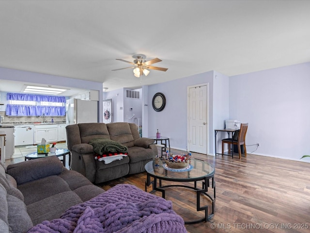 5229 Nowata Rd Unit F101, Bartlesville, OK 74006 - living area with wood finished floors and ceiling fan