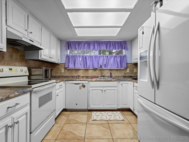 5229 Nowata Rd Unit F101, Bartlesville, OK 74006 - kitchen featuring white appliances, under cabinet range hood, white cabinets, backsplash, and light tile patterned floors
