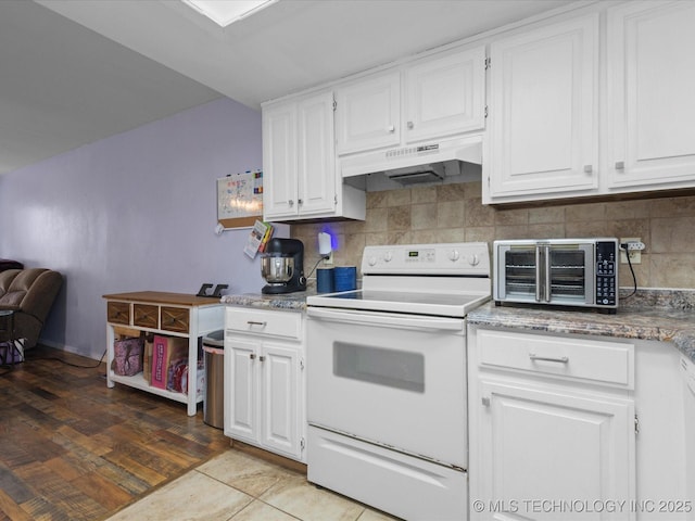 5229 Nowata Rd Unit F101, Bartlesville, OK 74006 - kitchen featuring white range with electric stovetop, under cabinet range hood, and white cabinetry