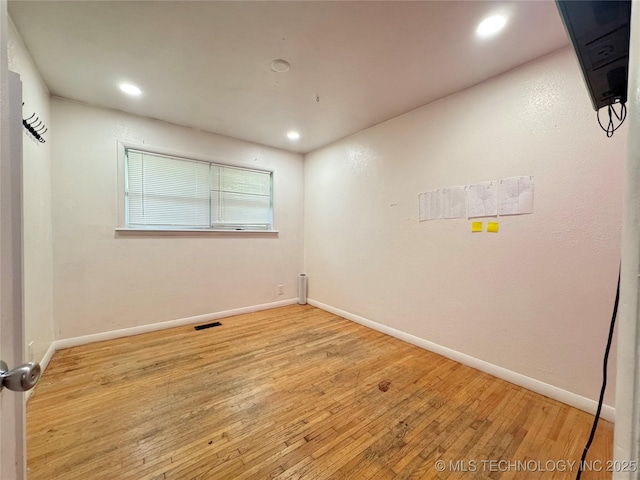 9763 E 3rd St, Tulsa, OK 74128 - spare room with hardwood / wood-style flooring and recessed lighting