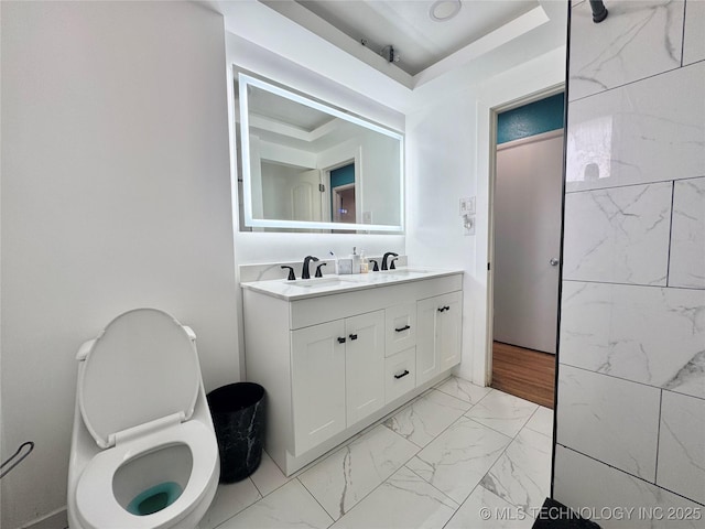 9763 E 3rd St, Tulsa, OK 74128 - bathroom with double vanity, marble look tiles, and a raised ceiling