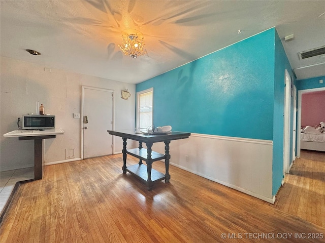 9763 E 3rd St, Tulsa, OK 74128 - dining area featuring wood finished floors and a chandelier
