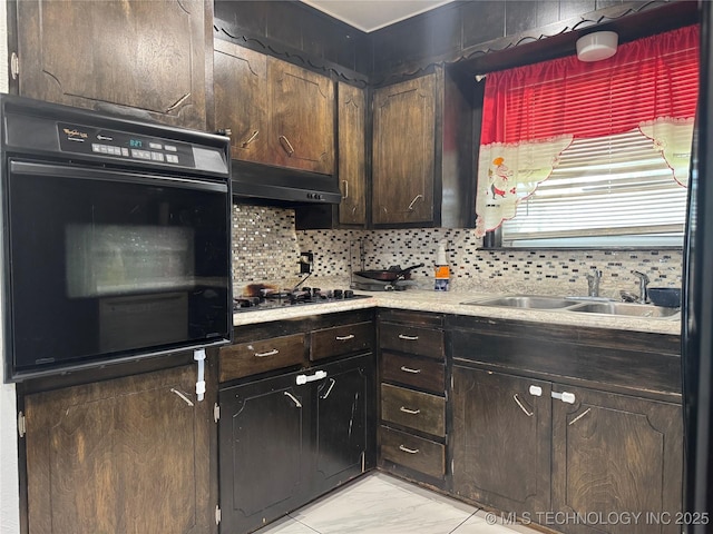 9763 E 3rd St, Tulsa, OK 74128 - kitchen featuring black oven, under cabinet range hood, light marble finish flooring, and tasteful backsplash