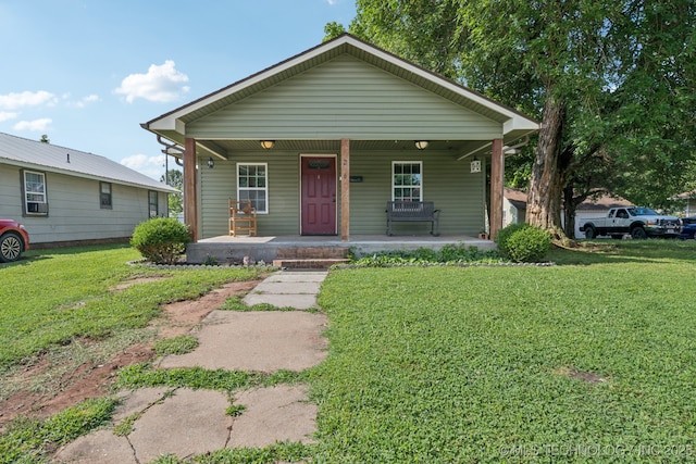 236 W 9th Ave, Bristow, OK 74010 - view of front of home featuring covered porch and a front lawn