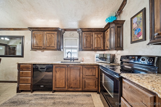 236 W 9th Ave, Bristow, OK 74010 - kitchen featuring black appliances, light stone countertops, a textured ceiling, light tile patterned floors, and a textured wall