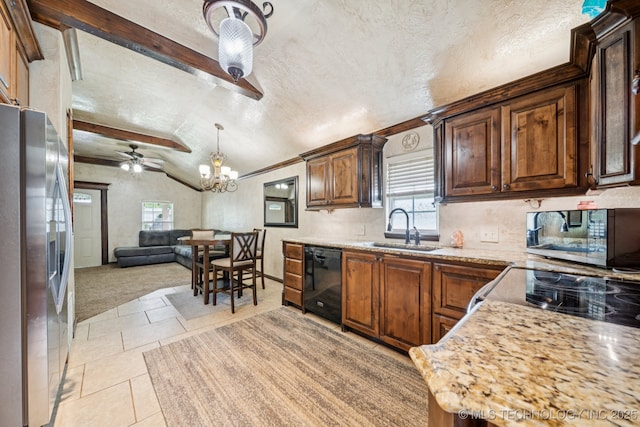 236 W 9th Ave, Bristow, OK 74010 - kitchen with stainless steel appliances, lofted ceiling, a chandelier, a textured ceiling, and open floor plan
