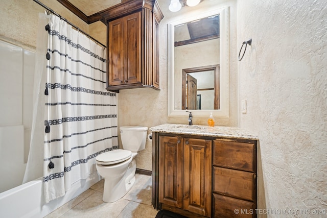 236 W 9th Ave, Bristow, OK 74010 - bathroom featuring a textured wall, vanity, tile patterned flooring, and shower / bath combo with shower curtain