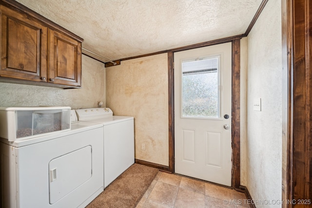 236 W 9th Ave, Bristow, OK 74010 - washroom featuring washer and clothes dryer, a textured ceiling, cabinet space, and a textured wall