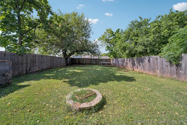 236 W 9th Ave, Bristow, OK 74010 - fenced backyard featuring a trampoline