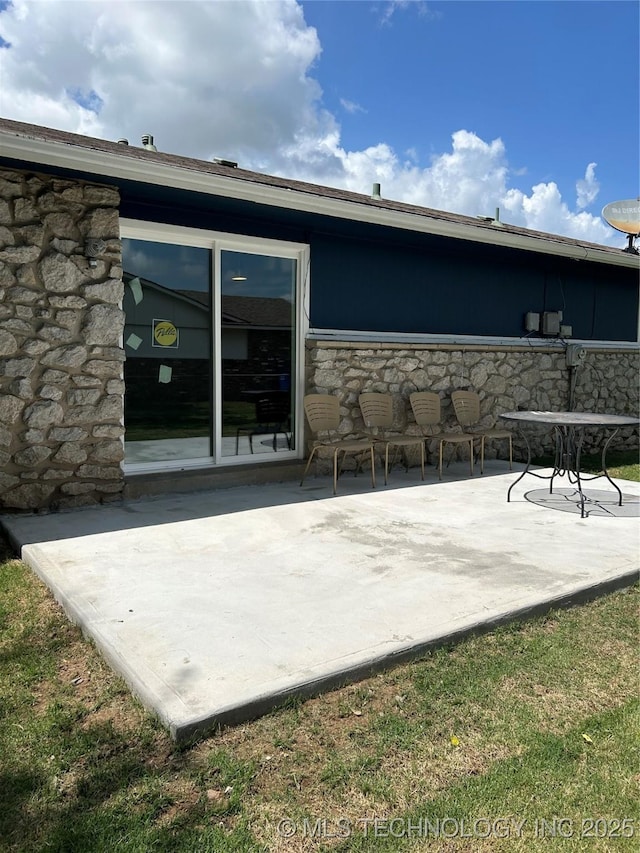 12976 E 32nd St, Tulsa, OK 74134 - rear view of house with a patio and stone siding