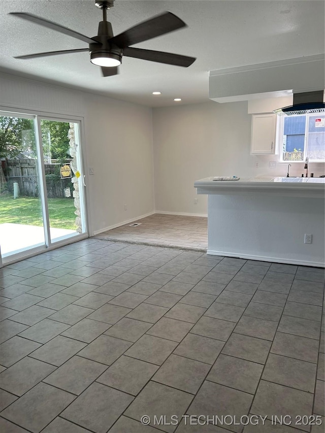 12976 E 32nd St, Tulsa, OK 74134 - unfurnished living room featuring a ceiling fan and recessed lighting