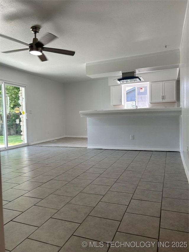12976 E 32nd St, Tulsa, OK 74134 - unfurnished living room featuring light tile patterned floors and ceiling fan