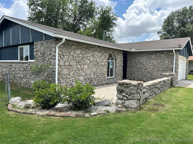 12976 E 32nd St, Tulsa, OK 74134 - view of property exterior with stone siding, a yard, and a garage