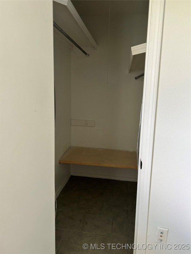 12976 E 32nd St, Tulsa, OK 74134 - walk in closet with dark tile patterned flooring