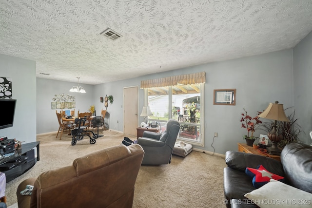 1222 N Cherrington Ave, Claremore, OK 74017 - carpeted living area with a textured ceiling and a chandelier