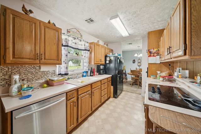 1222 N Cherrington Ave, Claremore, OK 74017 - kitchen featuring black appliances, light flooring, a textured ceiling, light countertops, and decorative backsplash