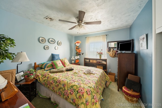 1222 N Cherrington Ave, Claremore, OK 74017 - carpeted bedroom featuring a textured ceiling and ceiling fan