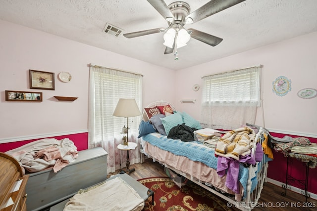 1222 N Cherrington Ave, Claremore, OK 74017 - bedroom with wood finished floors, ceiling fan, and a textured ceiling