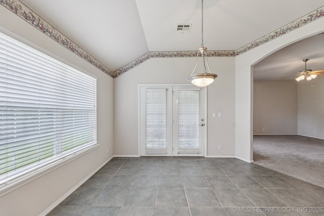 513 S 63rd Pl S, Broken Arrow, OK 74014 - unfurnished dining area with ceiling fan, tile patterned floors, vaulted ceiling, and arched walkways