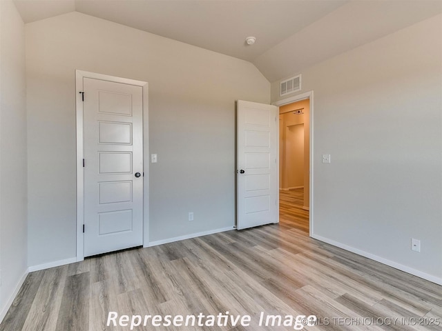 7218 E 132nd St S, Bixby, OK 74008 - unfurnished bedroom with lofted ceiling and light wood-style floors