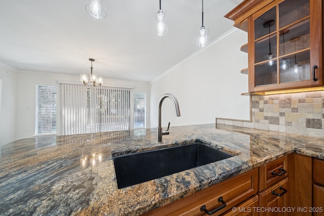 6002 S Atlanta Ct Unit 2, Tulsa, OK 74105 - kitchen with brown cabinetry, dark stone countertops, ornamental molding, pendant lighting, and decorative backsplash