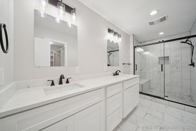 6002 S Atlanta Ct Unit 2, Tulsa, OK 74105 - bathroom with marble look tiles, a marble finish shower, double vanity, and recessed lighting
